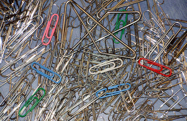 Everyday things, Multiple paper clips scattered on a plain surface
