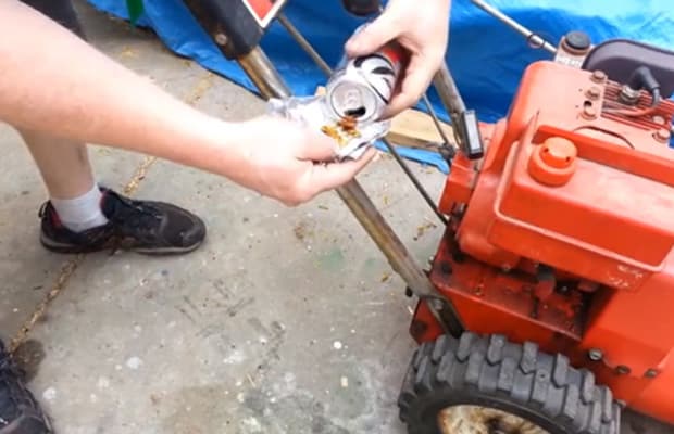 Coca cola can and lawn mower