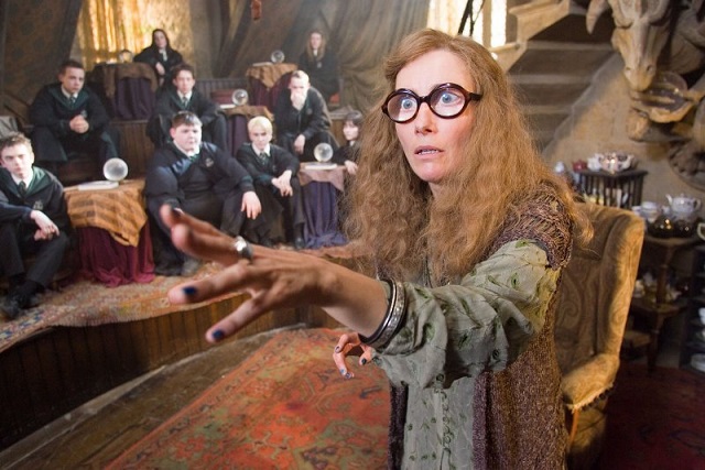 Sybill Trelawney is the Divination teacher at Hogwarts, and predicts the prophecy
